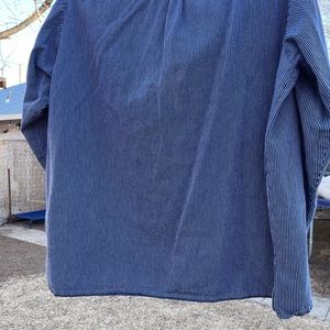 Women’s denim-like shirt with white stripes and buttons. Long sleeves.